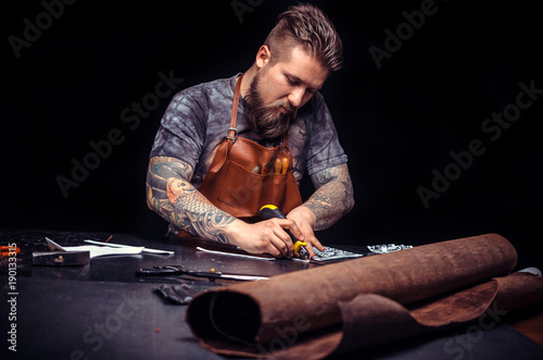 Artist working with leather keen on one's business