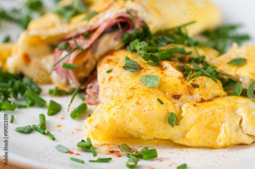 Fluffy egg omelette with ham and cheese, chive.