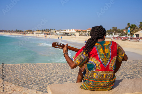 Musician with guitar and rasta hair at Santa Maria Beach, Sal, Cape Verde
