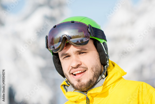 Portrait of a man dressed in snowboarding clothes outdoors at the mountains