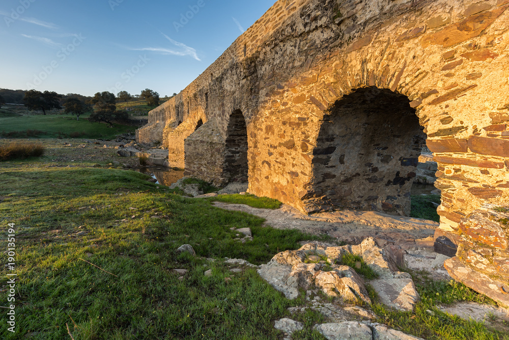 Ancient Roman bridge over the Salor river, located near Aliseda. Extremadura. Spain.