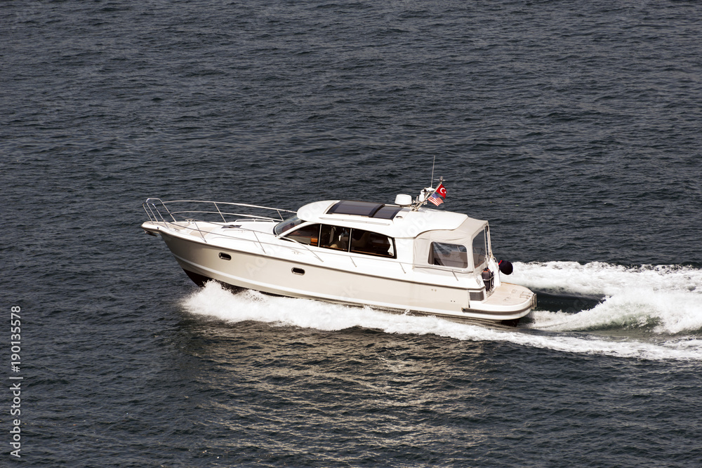 A white motorboat cruising in the sea A white motorboat cruising in the sea