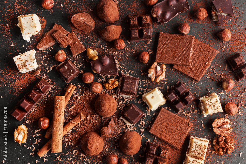 Variety of sweet homemade chocolate pralines on wooden background Variety of sweet homemade chocolate pralines on wooden background