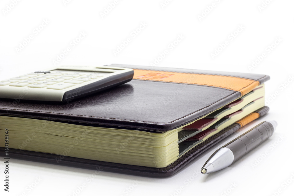 Diary with calculator and pen on white background, business manager set. Diary with calculator and pen on white background, business manager set.