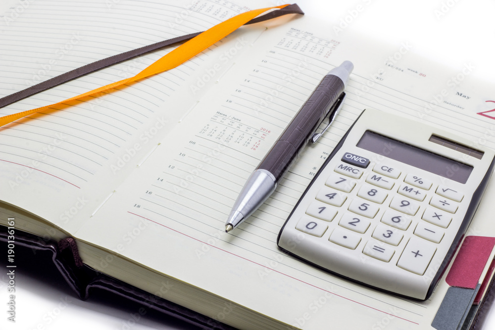 Diary with calculator and pen on white background, business manager set. Diary with calculator and pen on white background, business manager set.