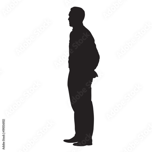 Adult man standing with his hands behind his back. Side view, vector isolated silhouette