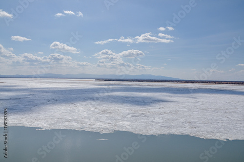 Kabelny and Big Ussuriysky islands and ice floes on Amur river on a sunny day in early spring Admiral Nevelsky embankment, Khabarovsk, Russia