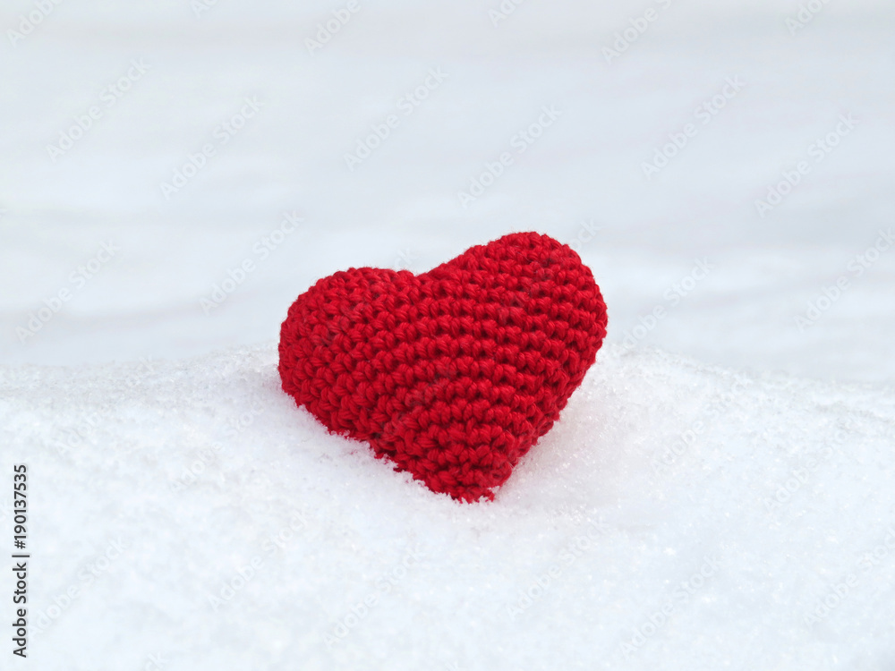 Pure love. St. Valentine's Day heart with free space. Knitted red heart on the snow. Donation symbol Pure love. St. Valentine's Day heart with free space. Knitted red heart on the snow. Donation symbol