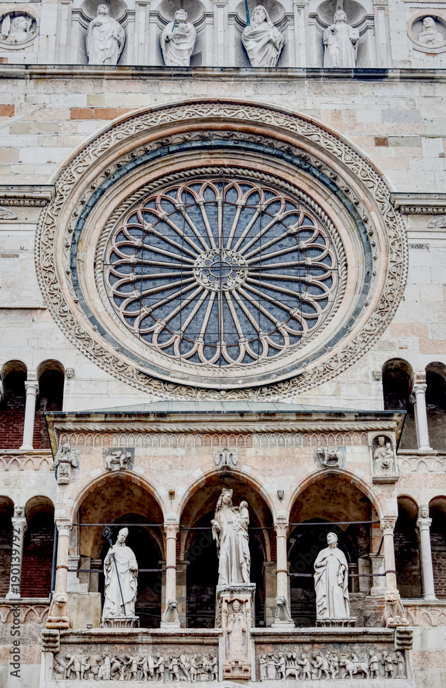 The rose window of the white marble facade of the Cremona Dome in northern Italy. HDR effect.