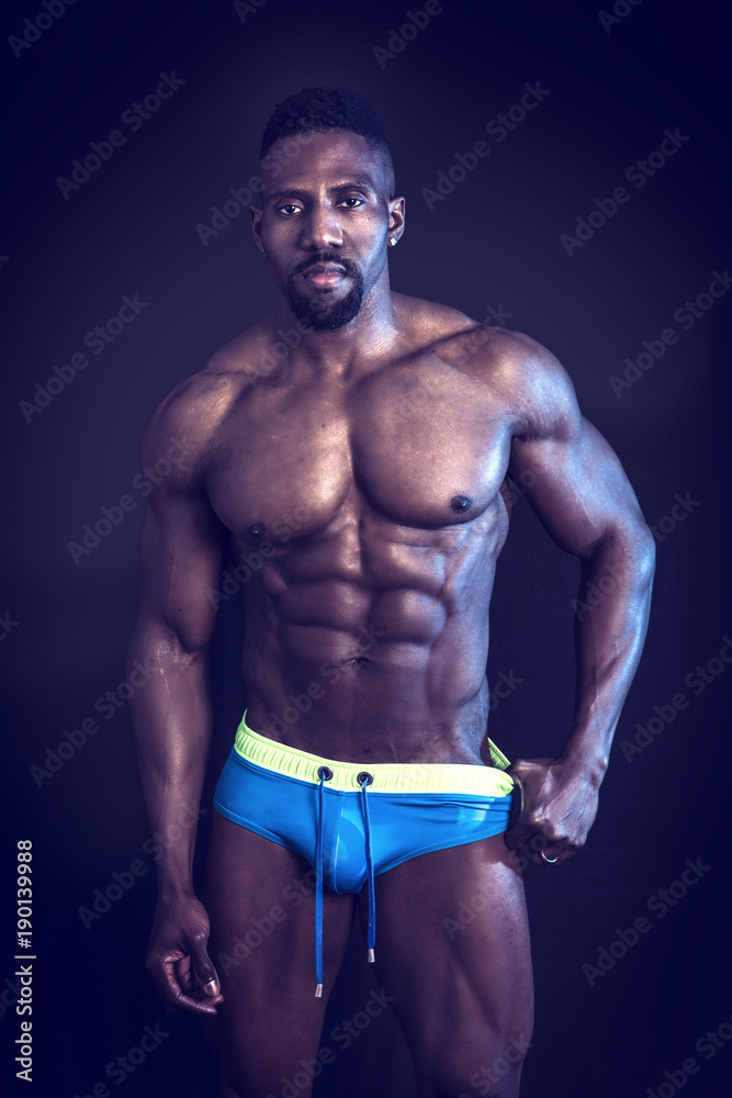 Fotografia do Stock: African American bodybuilder man, naked muscular  torso, wearing underwear, against black background