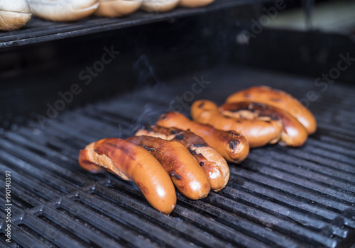 Large sausages grilling on a gas bbq grill