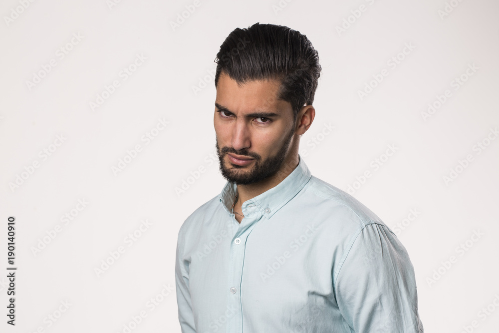 severe and harsh face expression of handsome young male isolated on white background severe and harsh face expression of handsome young male isolated on white background