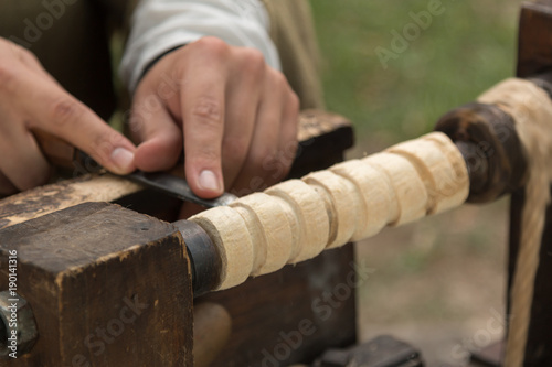 Carver at Work with Cutting Equipment during Medieval Country Festival