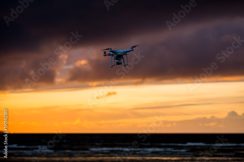 Flying drone over sea and cloud sky