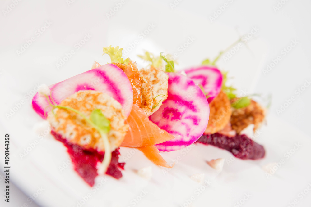 Smoked salmon with roasted beetroots sauce, russian pancakes and horseradish cream