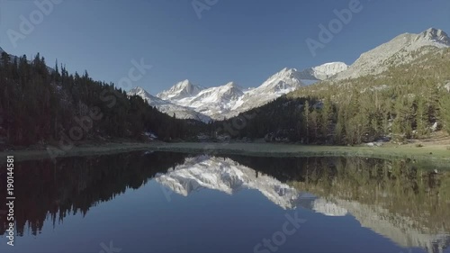Aerial Reveal Snow Mountain Valley with Mirror Lake reflection - Inyo National Forest, Little Lakes Valley Trail (Gem Lakes), Bishop, California
