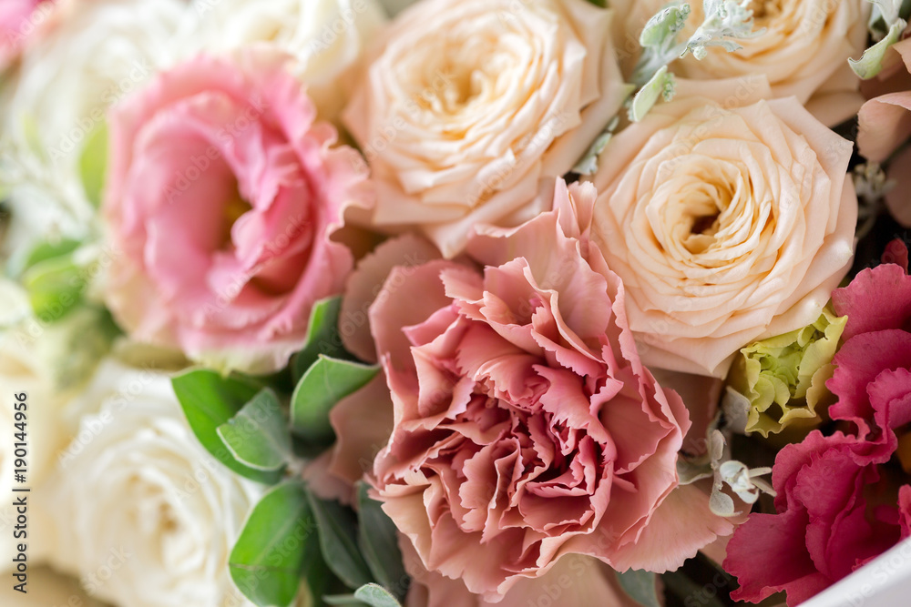 Close-up floral composition with roses and mix flowers on a light background. Close-up floral composition with roses and mix flowers on a light background.