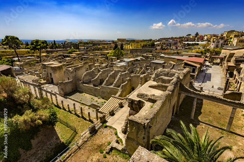 Italy. Ruins of Herculaneum (UNESCO World Heritage Site) - general view. There are the Palestra in the foreground and Decumanus Maximus in the right photo