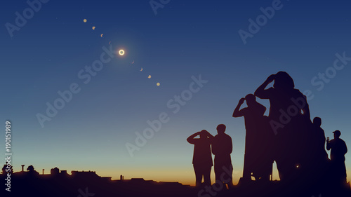 People are watching a solar eclipse in the sky with stars.  photo