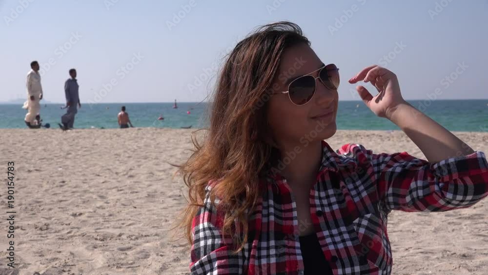 Business woman fixing her hair on the beach exotic vacation ocean holiday 4K Business woman fixing her hair on the beach exotic vacation ocean holiday 4K