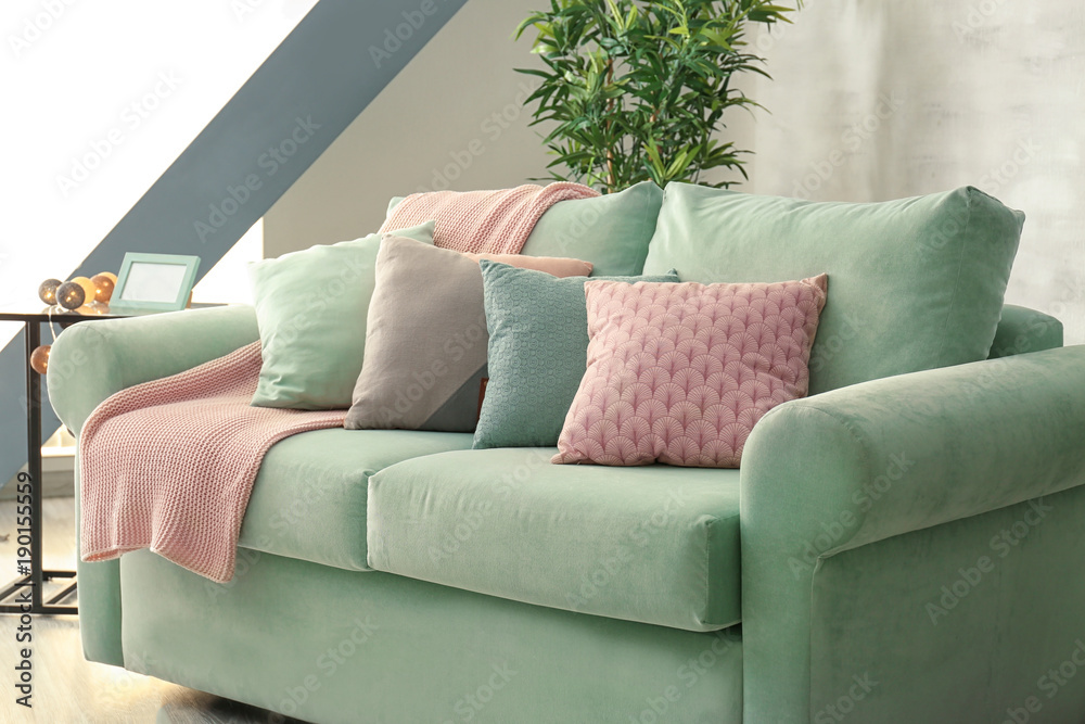 Comfortable mint couch with cushions in living room Stock Photo | Adobe  Stock