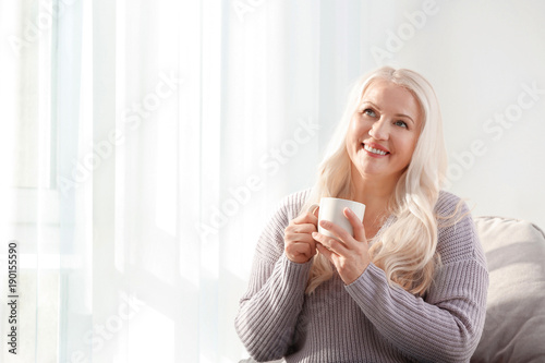 Mature smiling woman sittin...