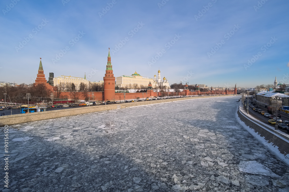Winter city landscape in Moscow with a view of the Kremlin and the embankments of the Moscow River in ice