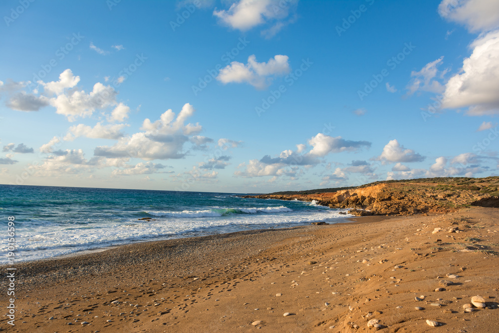 Beautiful view of the seashore at sunset in soft golden light. Toxeftra Beach, Cyprus