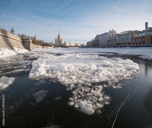 Winter city landscape in Moscow with a river in ice