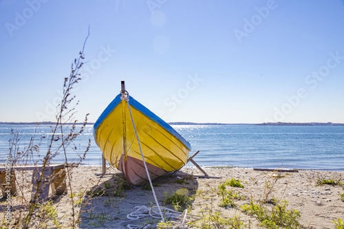 old wooden boat on the sandy shore. anchored boat on the sea coast. copy space for your text © EvgeniiAnd