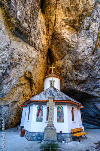 Ialomitei cave, Bucegi mountains, Saints Peter and Paul Church at the entrance. An orthodox Monastery built in a cave in Bucegi Mountains, Carpathians, Romania photo