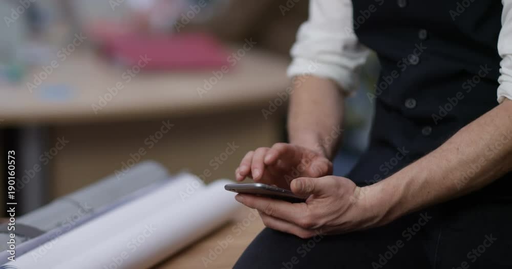 4K Close up on hands of businessman texting on smartphone. Slow motion.