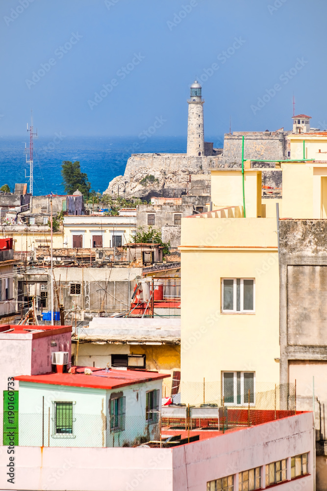 The famous Morro lighthouse and a view of old buildings in Havana