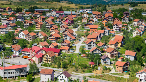 Residential buildings and houses in charming hilly landscape, aerial view