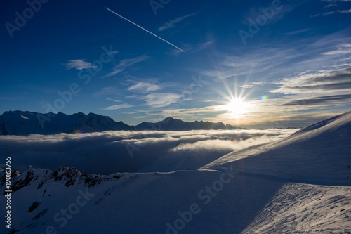 Magical sunset above clouds photo