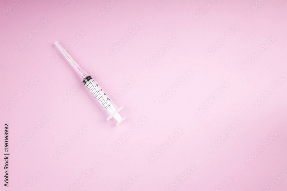 Syringe on a pastel background Syringe on a pastel background