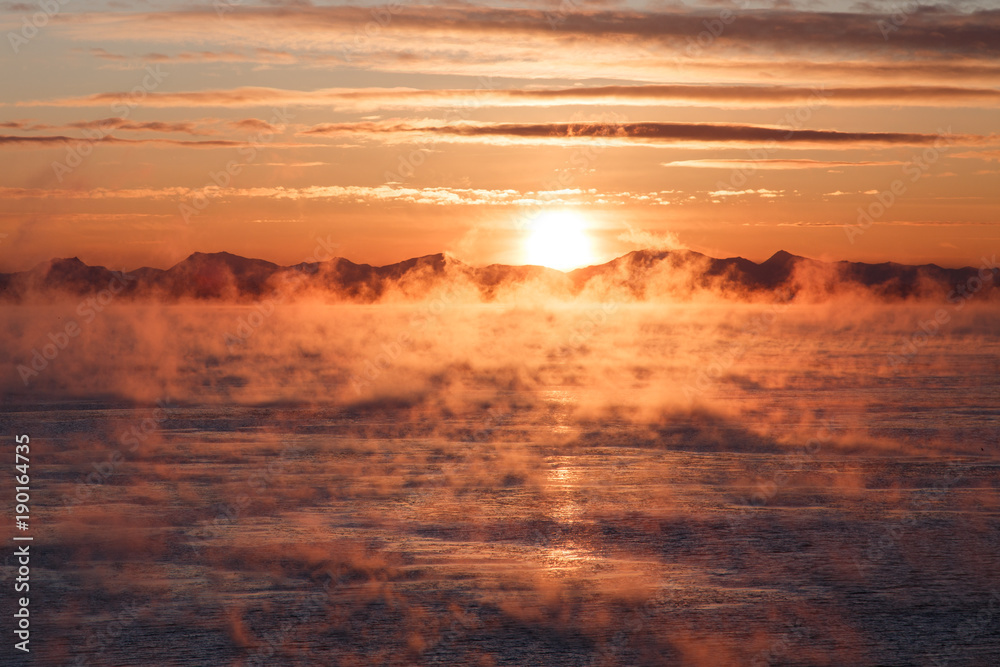 Fototapeta premium Cloudy sunrise over mountainous seacoast
