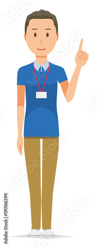 A male staff wearing a nameplate is pointing