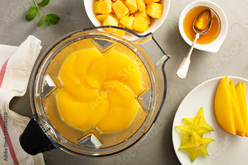 Making smoothie with frozen mango
