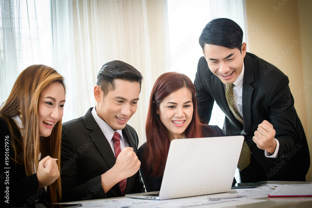 Happy business team enjoy good news together from email on laptop. Happy business team enjoy good news together from email on laptop.