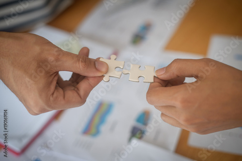 Hand holding jigsaw puzzles, Business partnership concept.