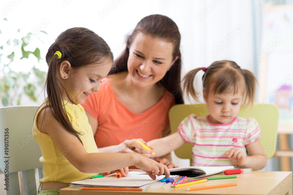 Teacher working with children in preschool classroom Teacher working with children in preschool classroom