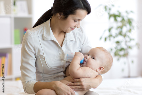 Mother feeding her baby on ...