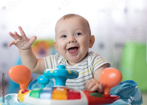 funny baby playing in baby walker