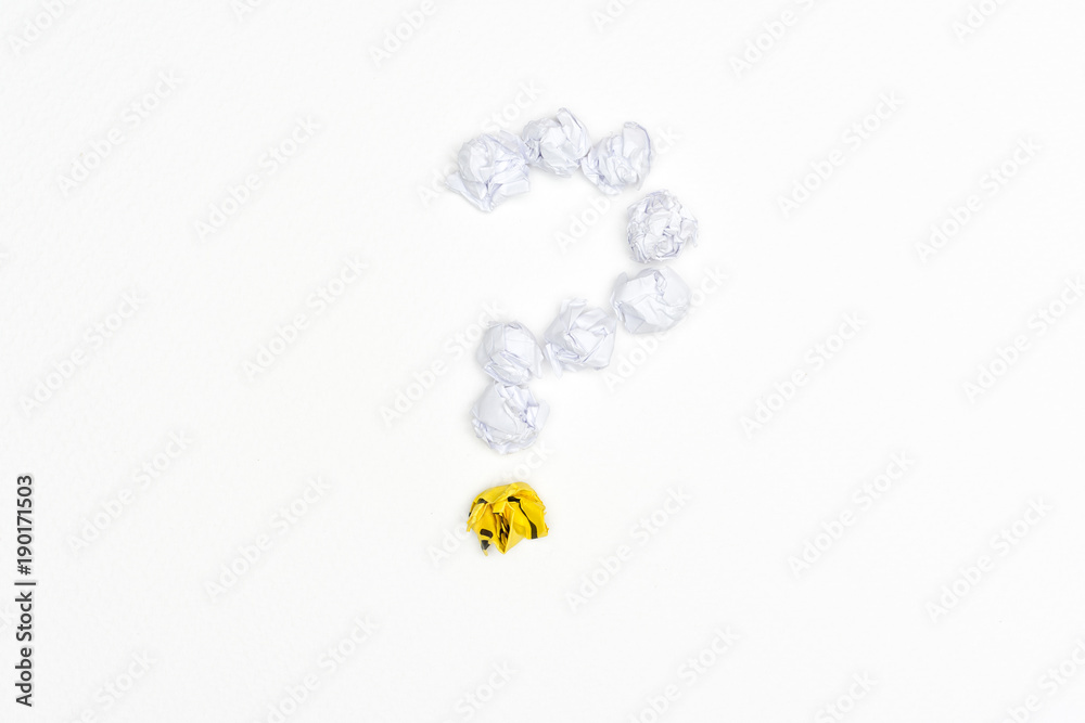 Question mark sign with crumpled paper balls on white background