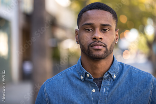 Young black man serious face portrait photo