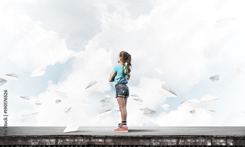 Concept of careless happy childhood with girl looking far away Concept of careless happy childhood with girl looking far away