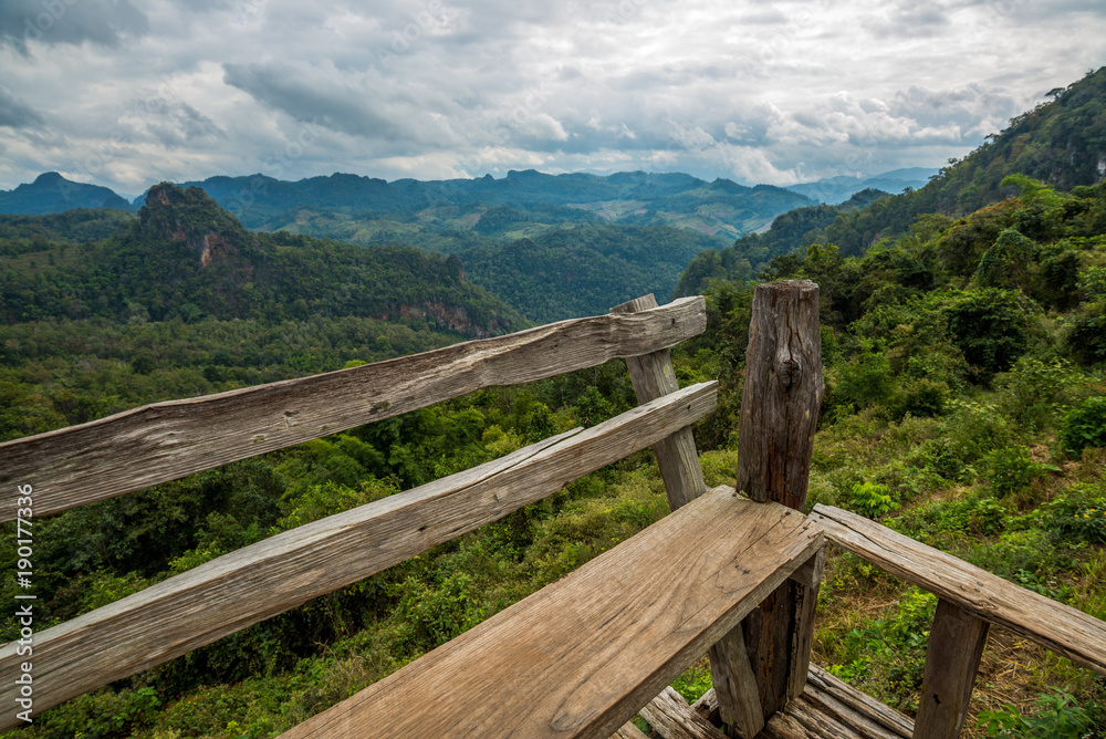 Wooden seat terrace for stand to look a landscape mountain view, North of Thailand Wooden seat terrace for stand to look a landscape mountain view, North of Thailand
