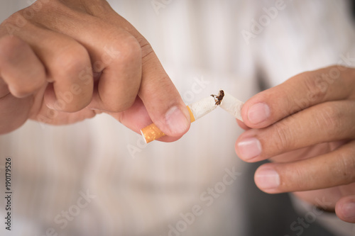 old man hand breaking cigarette  quit smoking concept