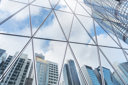 Photography Reflection of urban skyline on modern office building